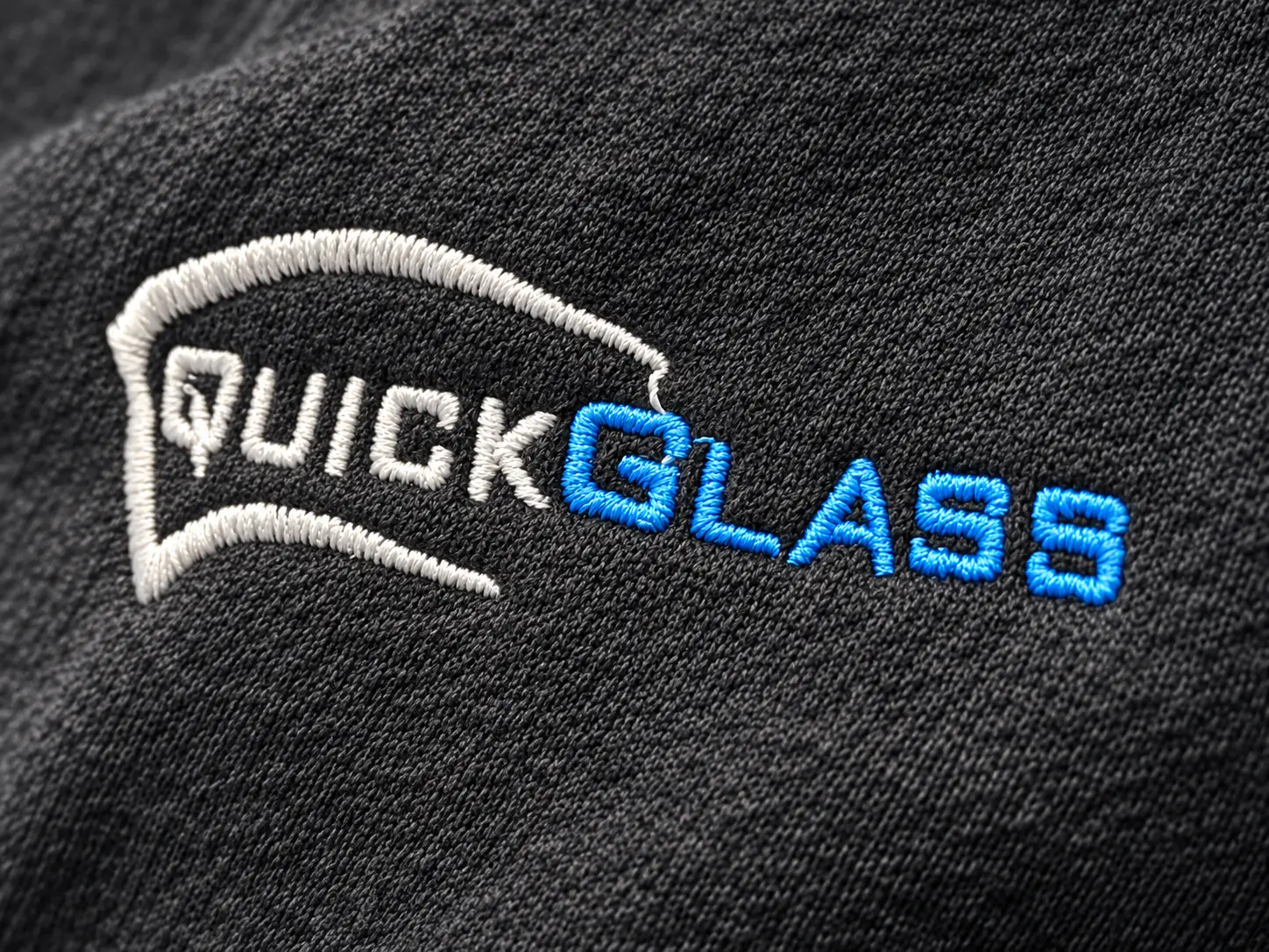 QuickGlass logo embroidered on a technician's uniform