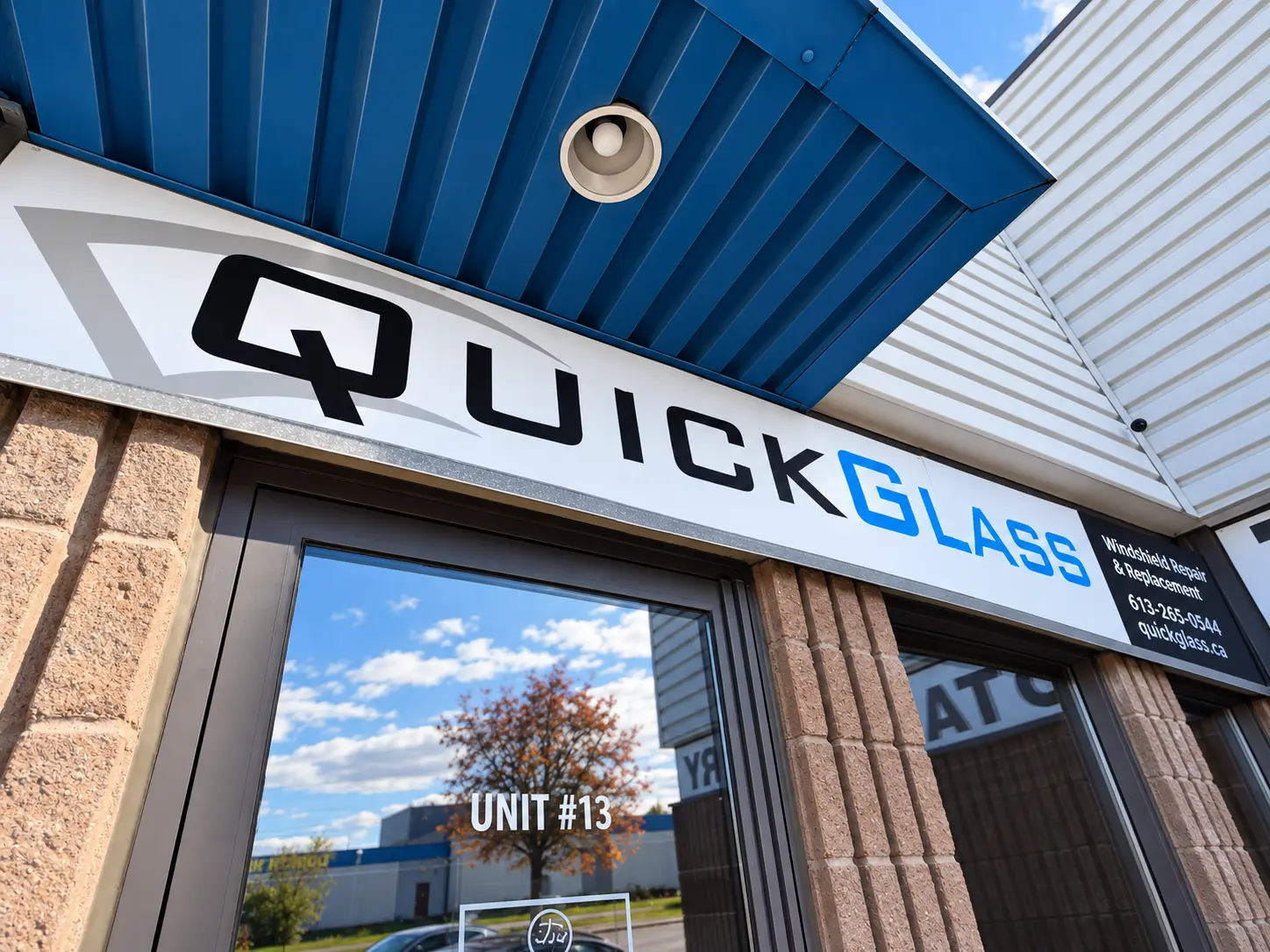 QuickGlass auto glass shop storefront under its blue canopy in Ottawa
