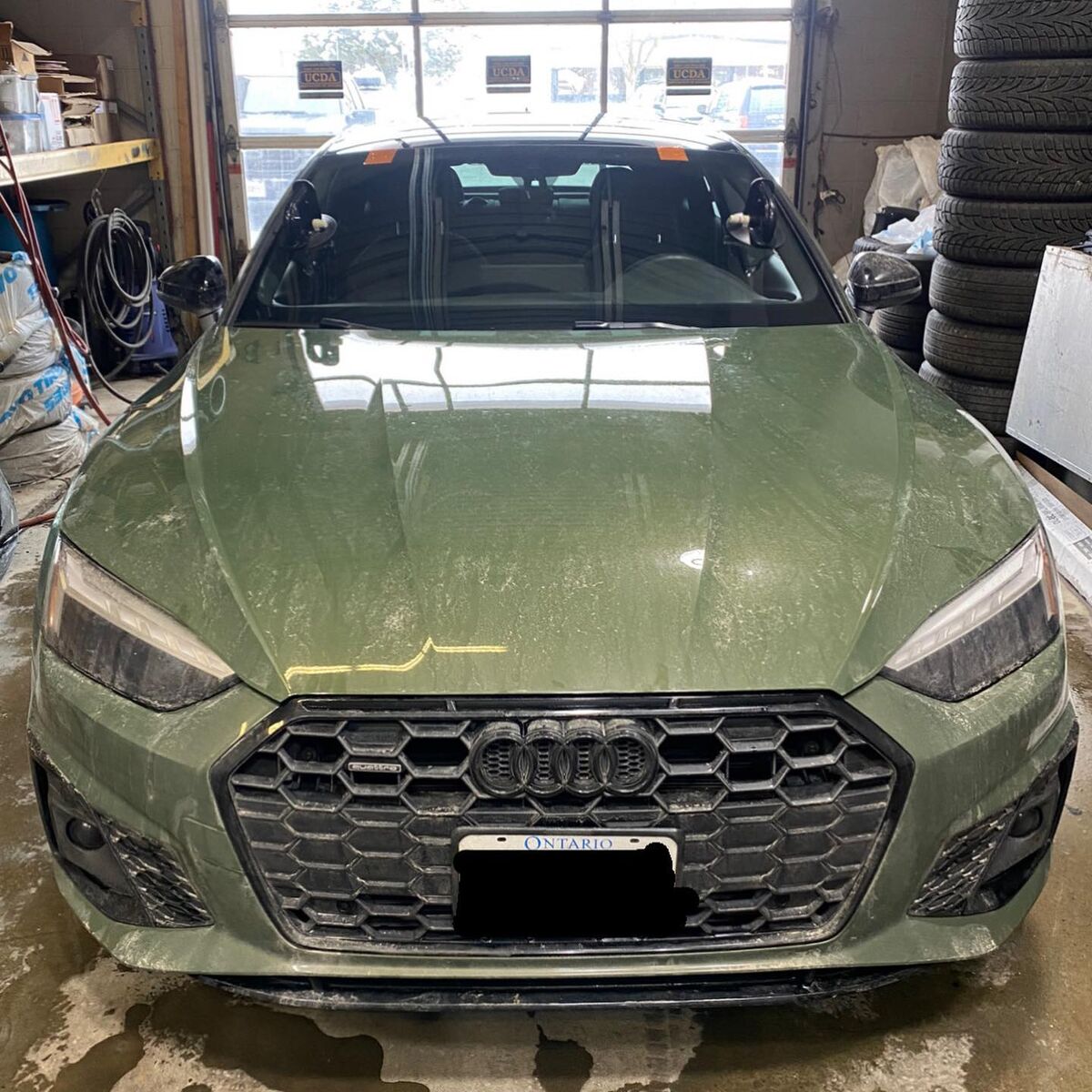 Green Audi A5 windshield replacement in the QuickGlass shop