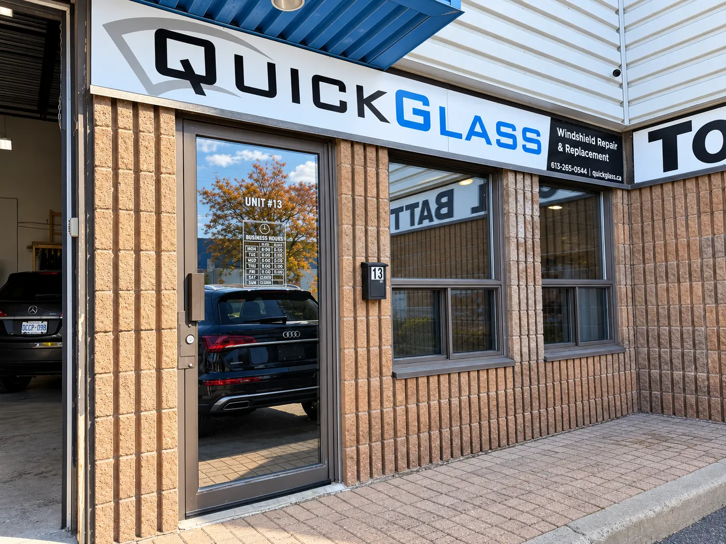 Entrance to the QuickGlass windshield shop in daylight